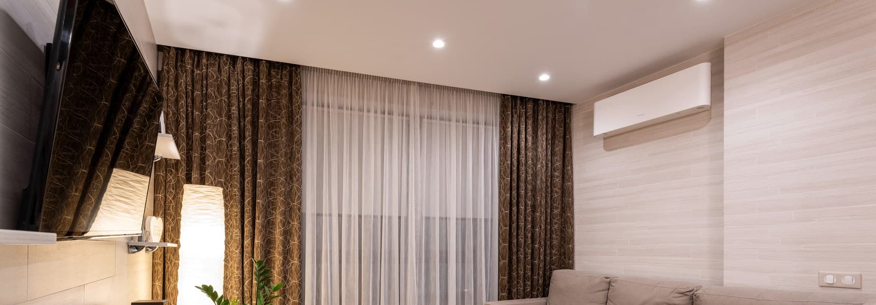 A wall-mounted air conditioning unit cooling a finished living room