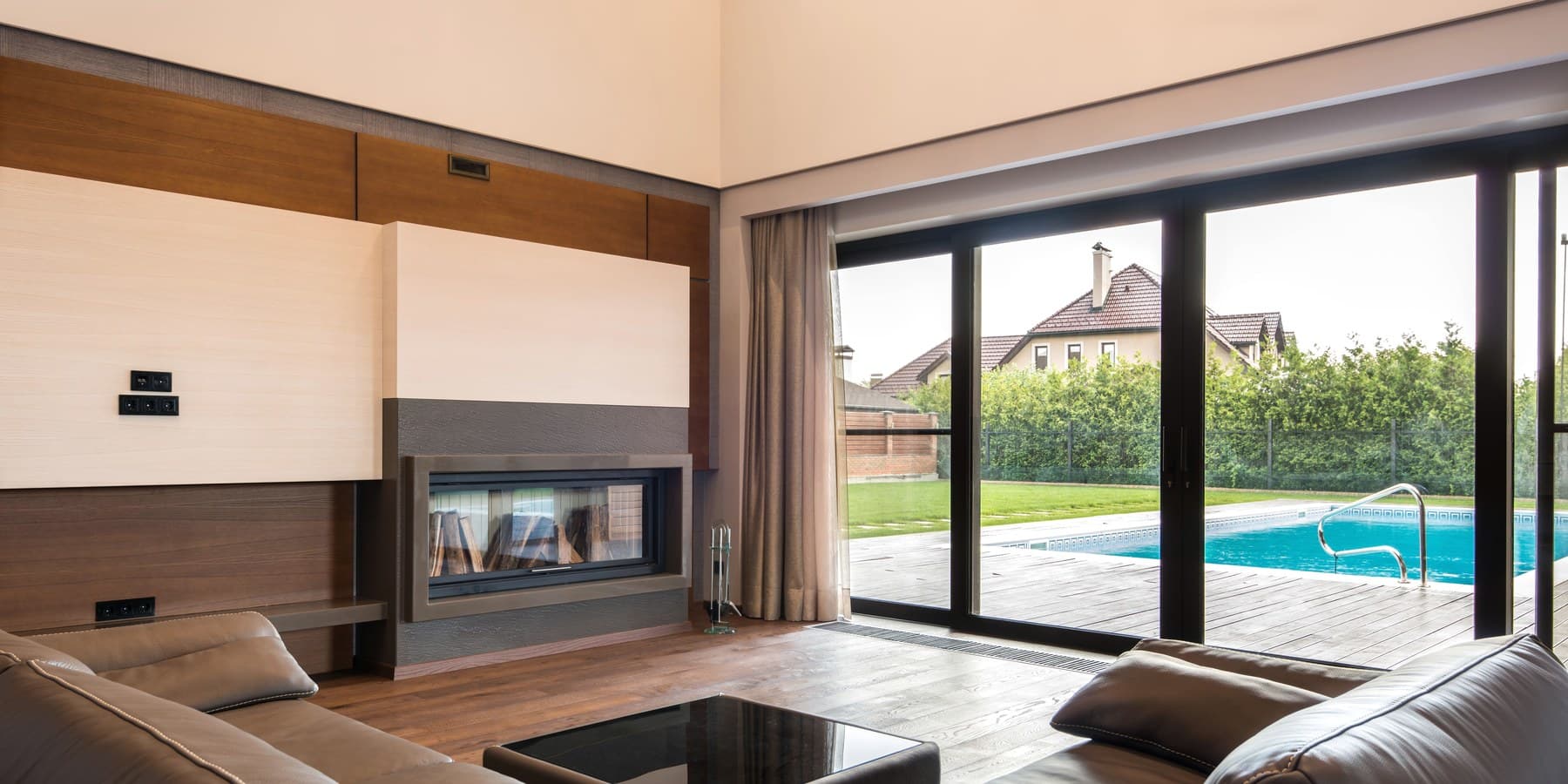 New sliding glass doors opening a living room to the pool